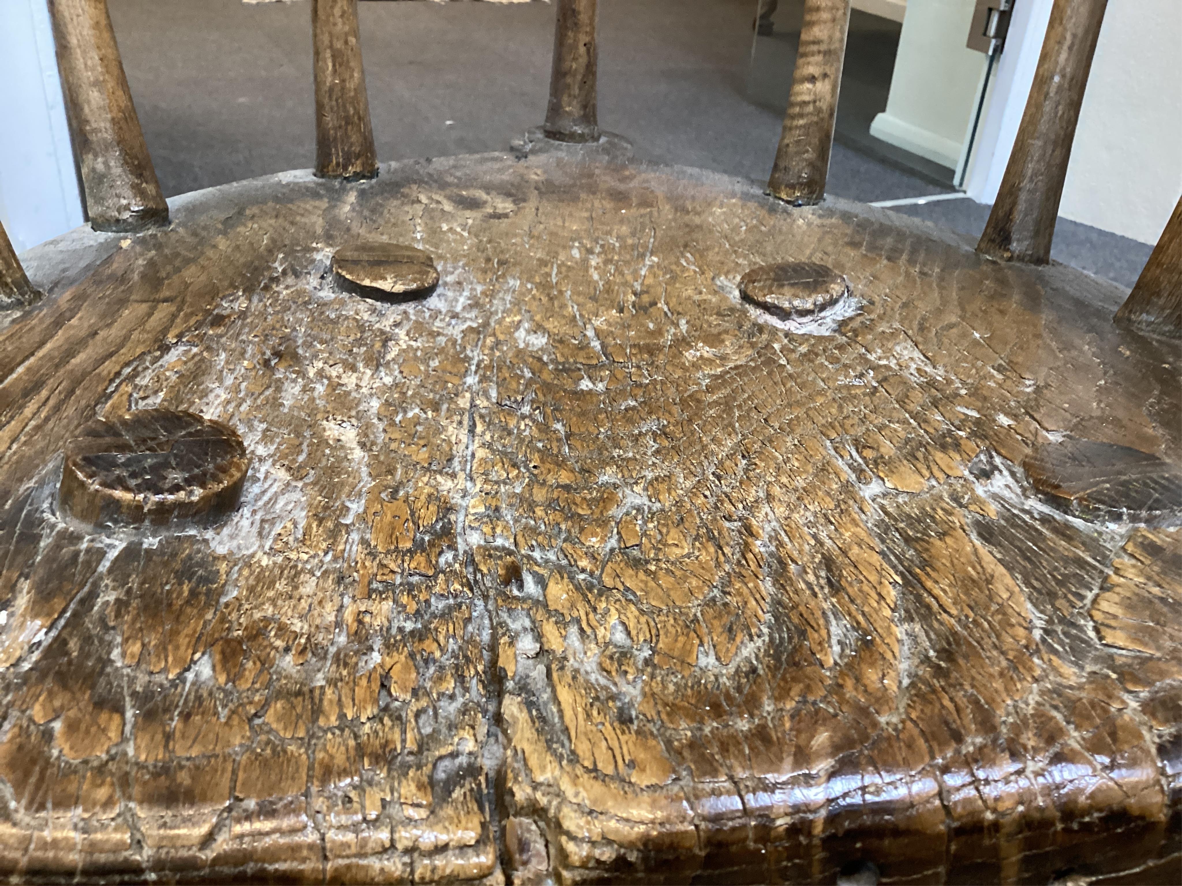 An 18th or 19th century primitive ash and elm Windsor armchair